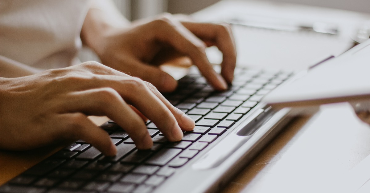 hands typing on keyboard